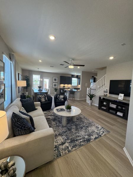 A modern living room with cozy seating, sleek decor, and warm lighting, featuring a stylish area rug and wooden flooring. A modern living room with cozy seating, sleek decor, and warm lighting, featuring a stylish area rug and wooden flooring.
