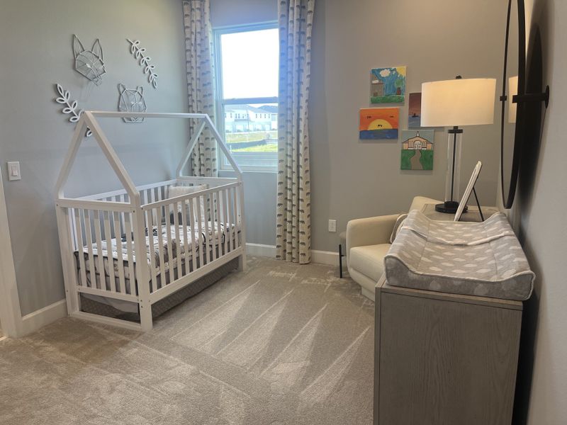 A cozy nursery featuring a white crib, plush carpeting, and playful decor, perfect for a peaceful child's room.