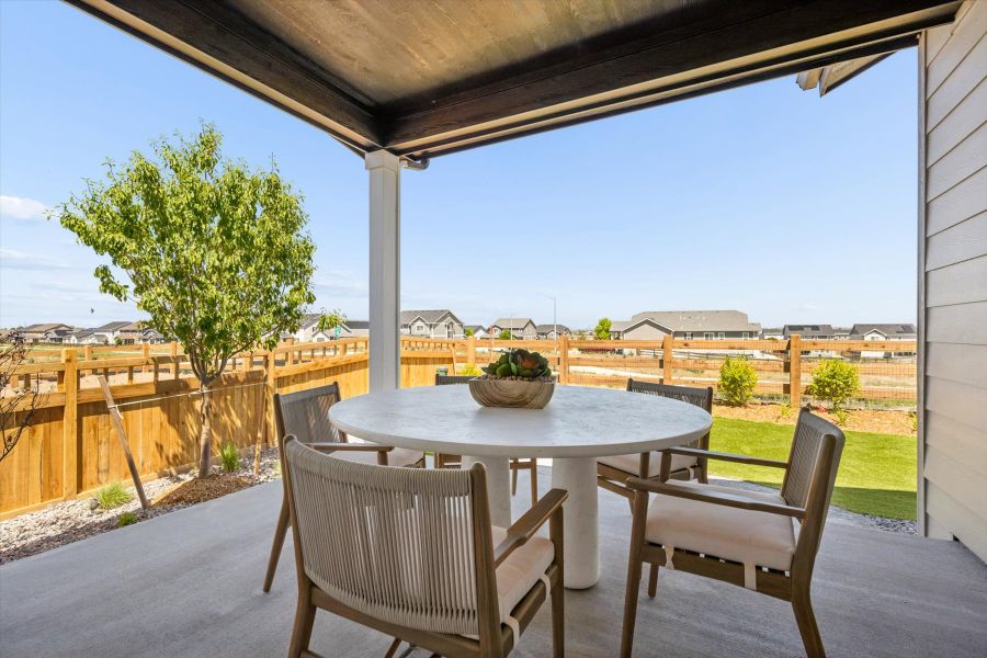 A table and chairs on a deck. A table and chairs on a deck.