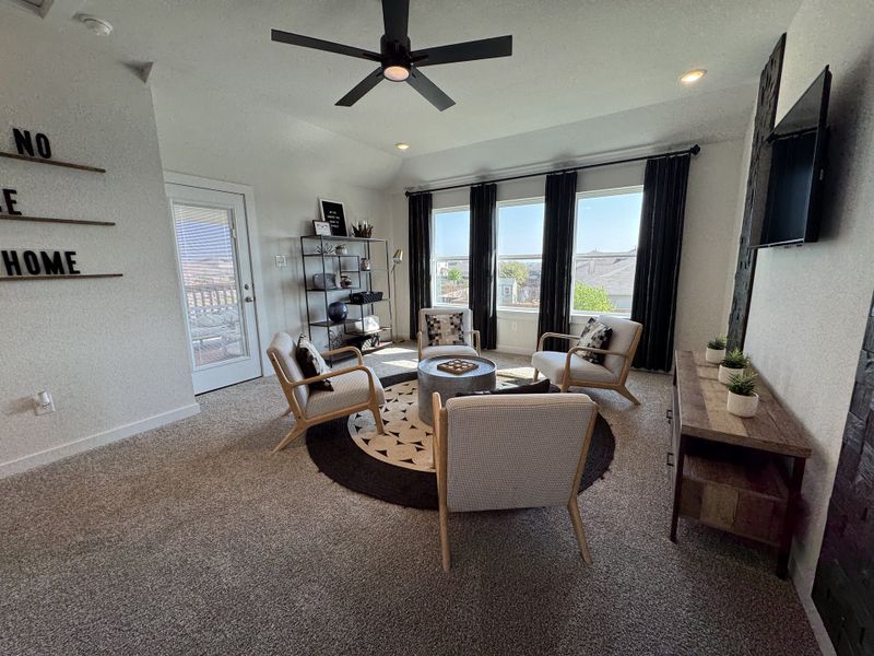 A cozy living room with modern furnishings, large windows, and a ceiling fan, creating a bright and inviting atmosphere. A cozy living room with modern furnishings, large windows, and a ceiling fan, creating a bright and inviting atmosphere.