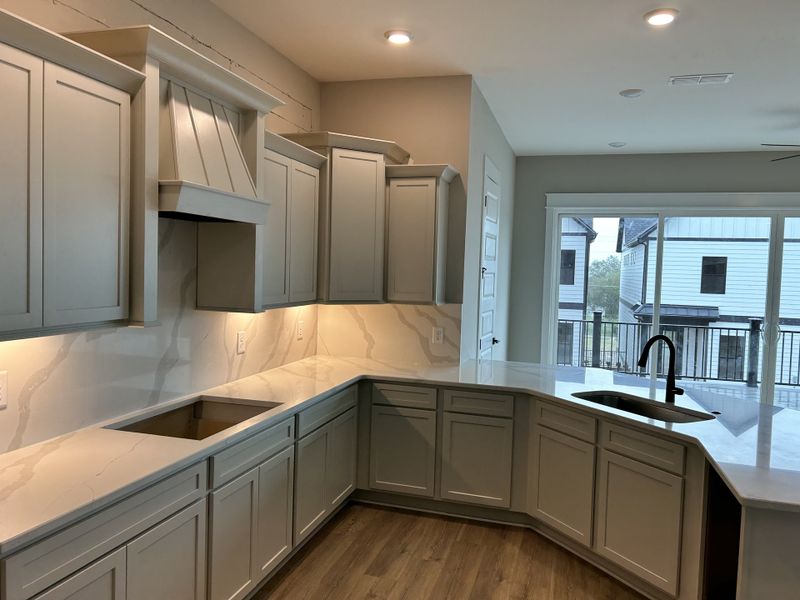 Quartz countertops in kitchen that extend as the backsplash for a seamless look Quartz countertops in kitchen that extend as the backsplash for a seamless look