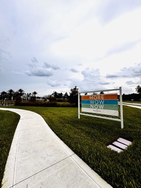 A scenic pathway in RiverTown - WaterSong by Mattamy Homes, St. Johns, FL, with a welcoming sign and lush greenery. A scenic pathway in RiverTown - WaterSong by Mattamy Homes, St. Johns, FL, with a welcoming sign and lush greenery.