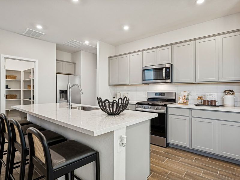 A kitchen with white cabinets.