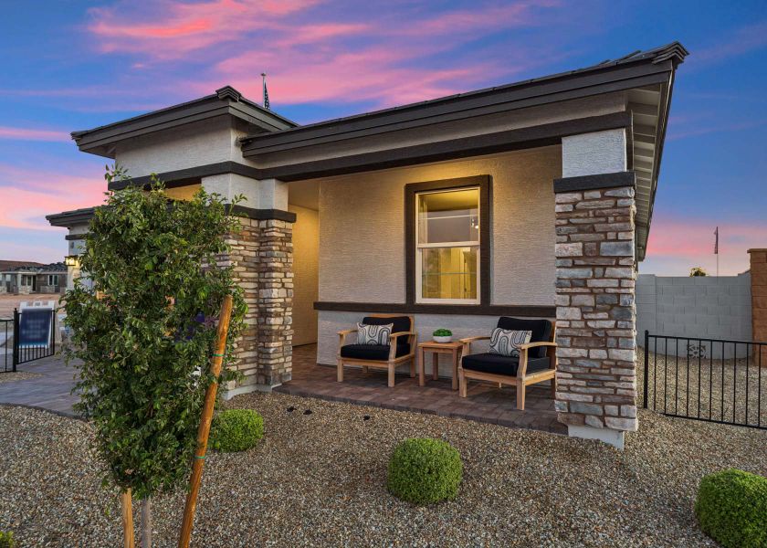 A house with a patio and a table and chairs outside.