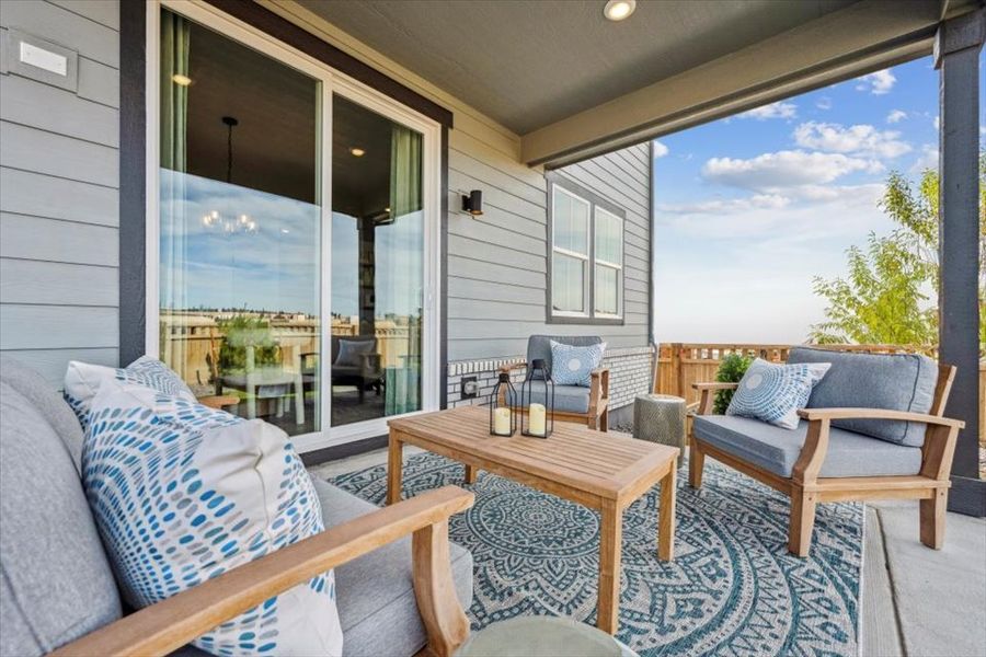A living room with a table and chairs.
