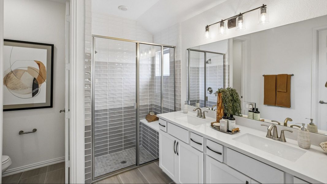 Luxurious bathroom in Cypress Green features sleek dual sinks and elegant glass shower enclosure. Luxurious bathroom in Cypress Green features sleek dual sinks and elegant glass shower enclosure.