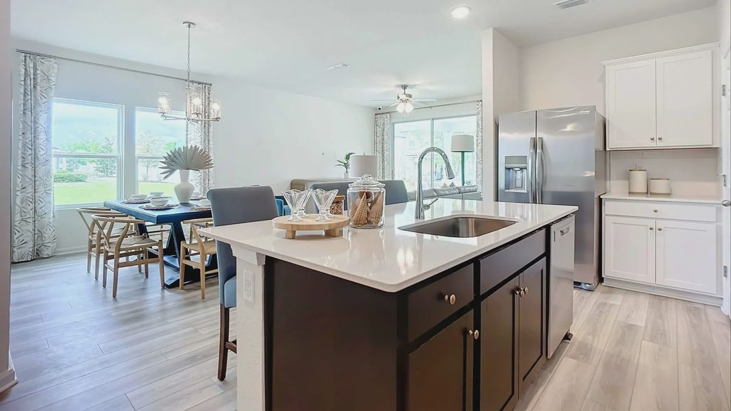 Luxurious kitchen with quartz island, stainless appliances, and designer lighting in Panther Creek.