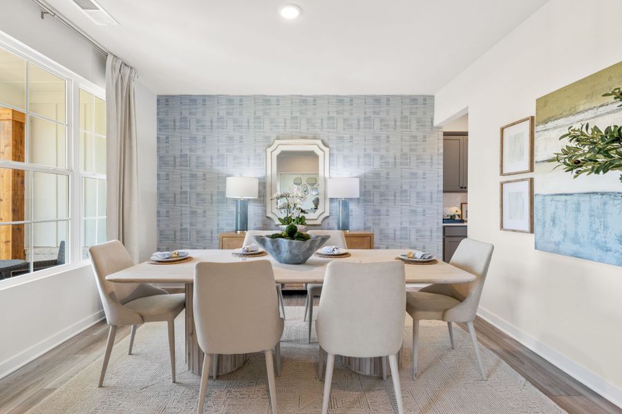A dining room with a round table.