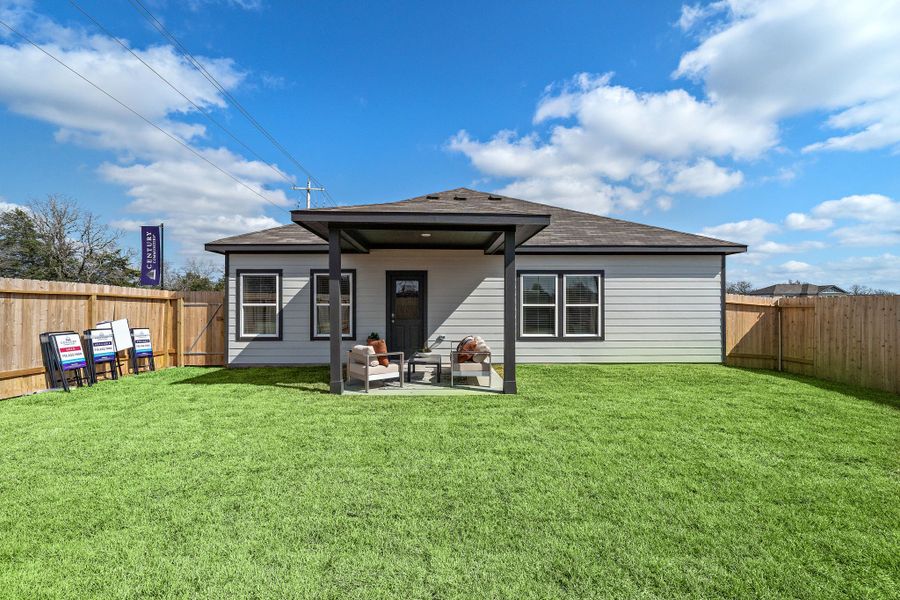 A person sitting in a chair outside a house. A person sitting in a chair outside a house.