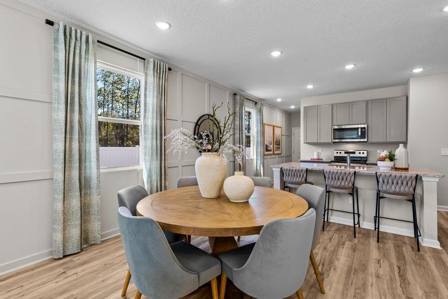 A kitchen with a dining table. A kitchen with a dining table.