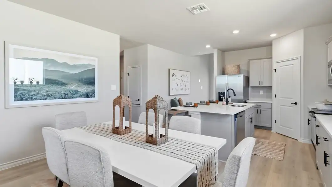 Furnished interior in a model home at The Woodlands at Medina Hills in Mico (Image 24).