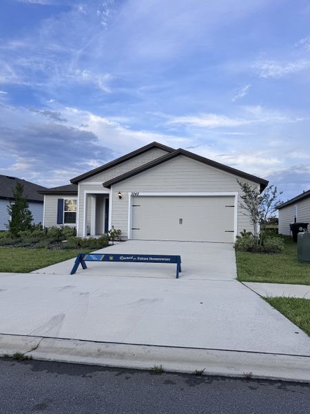 A modern gray siding home with a manicured lawn in Rolling Hills by LGI Homes (Green Cove Springs, FL).