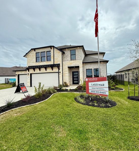 Elegant stone facade with manicured lawn at Lago Mar by CastleRock Communities in La Marque, TX.