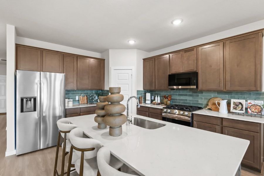 A kitchen with a table and chairs. A kitchen with a table and chairs.
