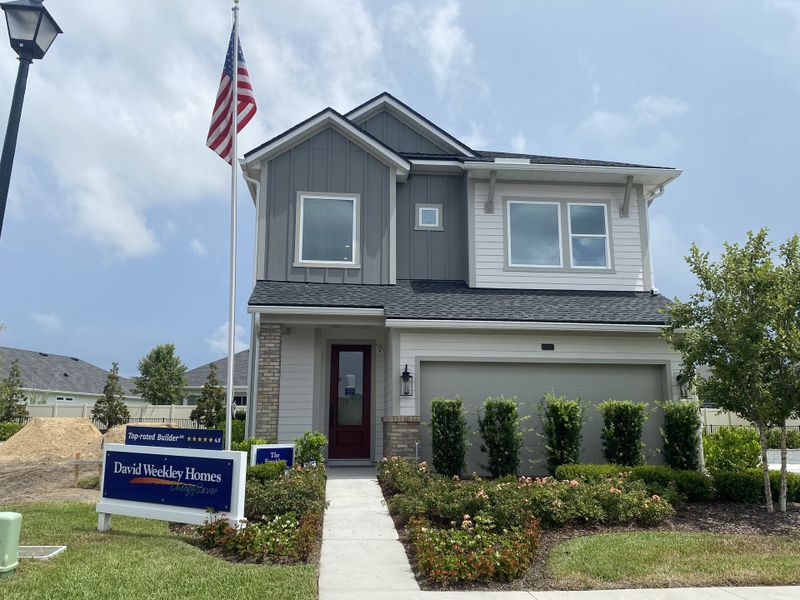 A modern two-story home with lush landscaping in Granville at eTown 38' by David Weekley Homes (Jacksonville, FL).