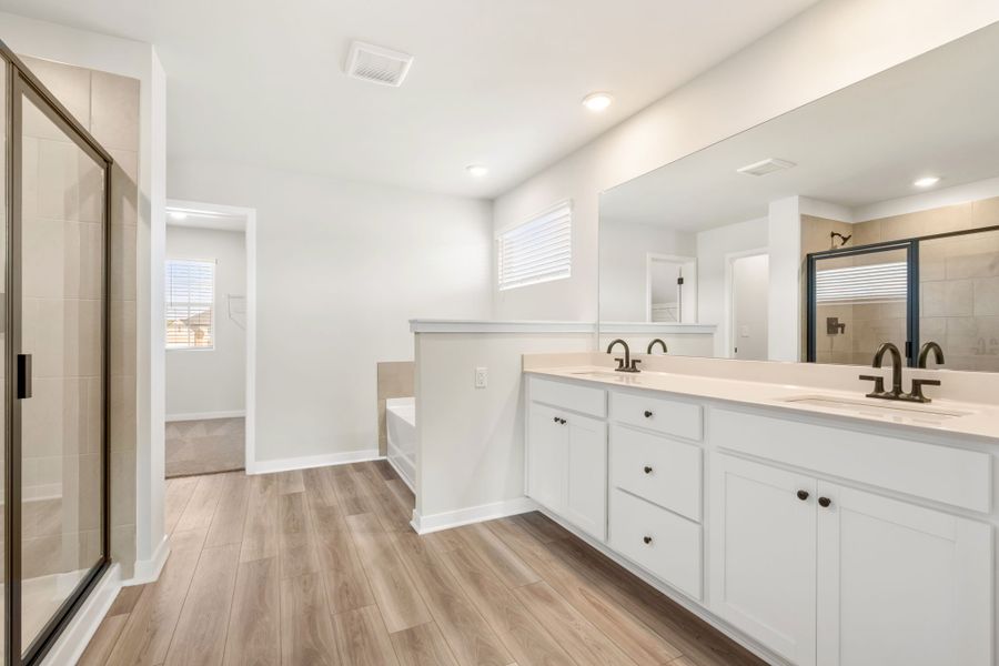 A bathroom with white cabinets. A bathroom with white cabinets.