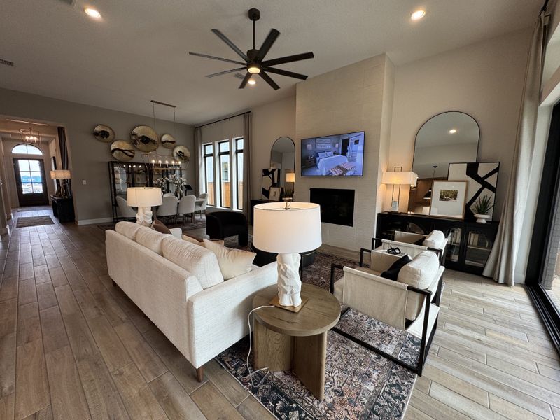 A modern living area featuring sleek furniture, a large TV, a cozy rug, and elegant lighting, exuding contemporary comfort.