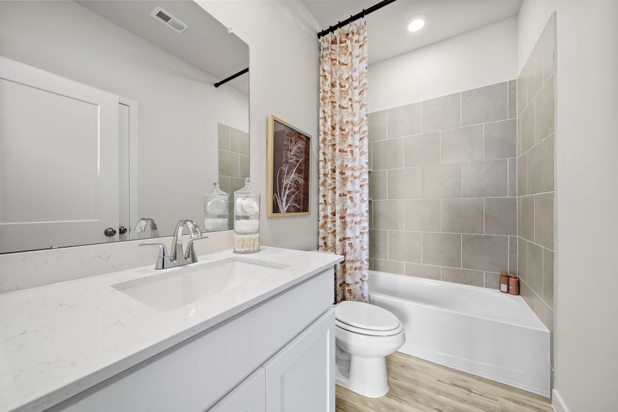 A bathroom with a tub toilet and sink. A bathroom with a tub toilet and sink.