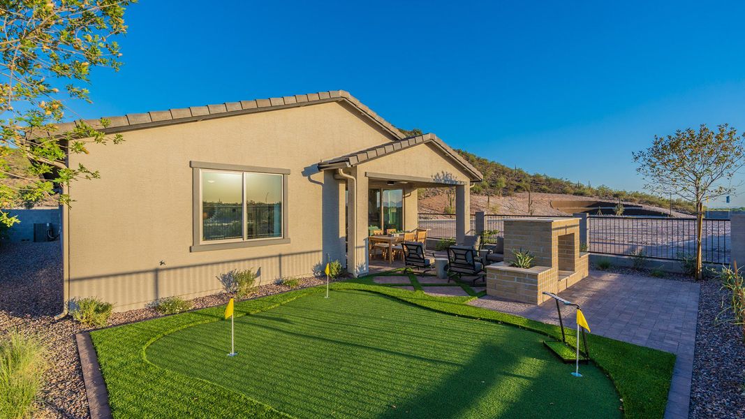 Luxurious villa with private putting green, elegant patio, and built-in brick grill in scenic Mystic community.