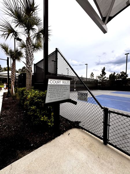 A tennis court with palm trees in RiverTown - WaterSong by Mattamy Homes (St. Johns, FL). A tennis court with palm trees in RiverTown - WaterSong by Mattamy Homes (St. Johns, FL).