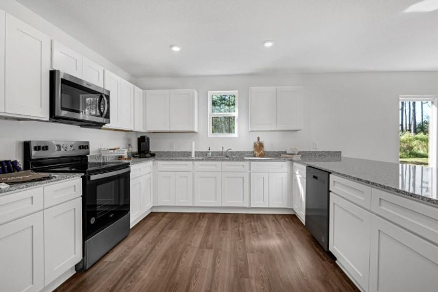 A kitchen with white cabinets. A kitchen with white cabinets.