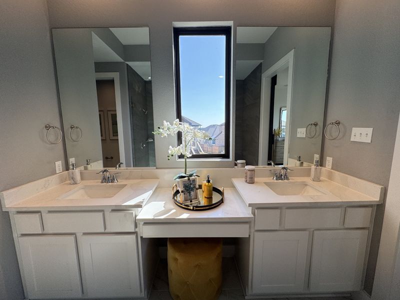 Elegant bathroom with dual sinks, marble countertops, and a large window accentuating natural light. Elegant bathroom with dual sinks, marble countertops, and a large window accentuating natural light.