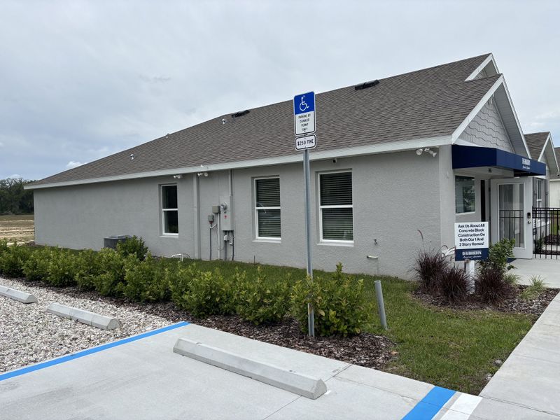 A modern gray building with landscaped greenery in Autumn Glen by D.R. Horton (Belleview, FL).