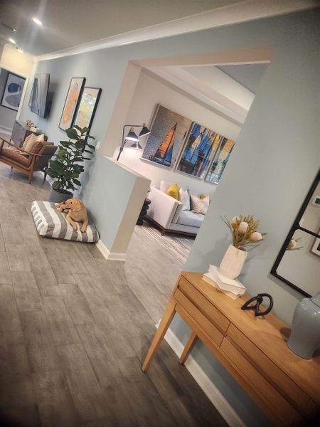 A cozy living space with blue walls, modern decor, wooden furniture, and artistic accents creating an inviting atmosphere.