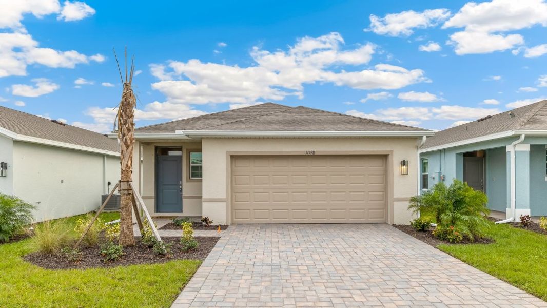 Front exterior of a home in the Coral Lakes - Tradition & Express community, located in Punta Gorda, FL (Image 16).
