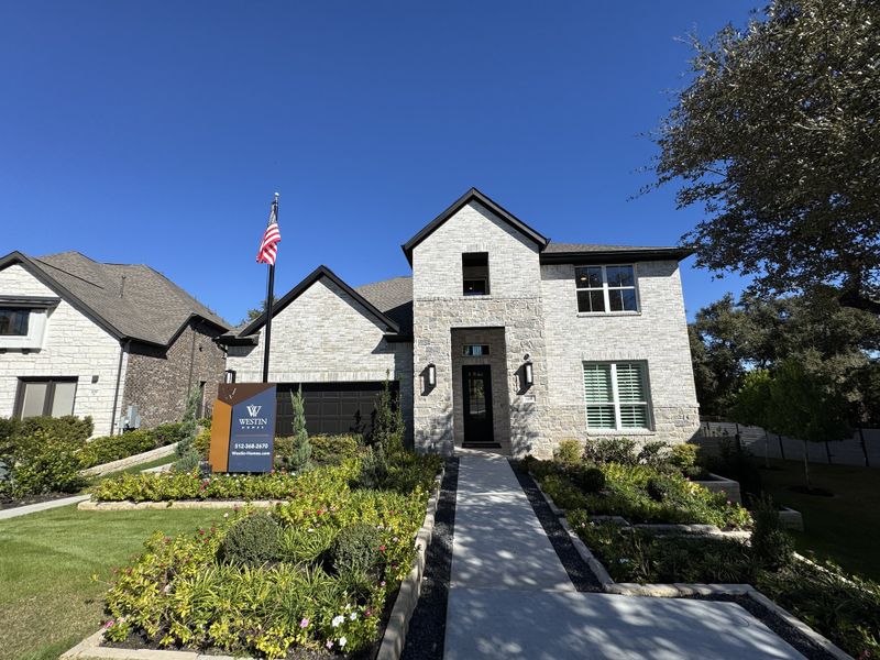 A beautiful stone home with manicured landscaping in Wolf Ranch - 55' by Westin Homes (Georgetown, TX). A beautiful stone home with manicured landscaping in Wolf Ranch - 55' by Westin Homes (Georgetown, TX).
