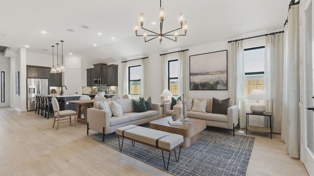 Luxurious open space with hardwood floors, sleek cabinetry, and chic chandelier in Oakwood Estates. Luxurious open space with hardwood floors, sleek cabinetry, and chic chandelier in Oakwood Estates.