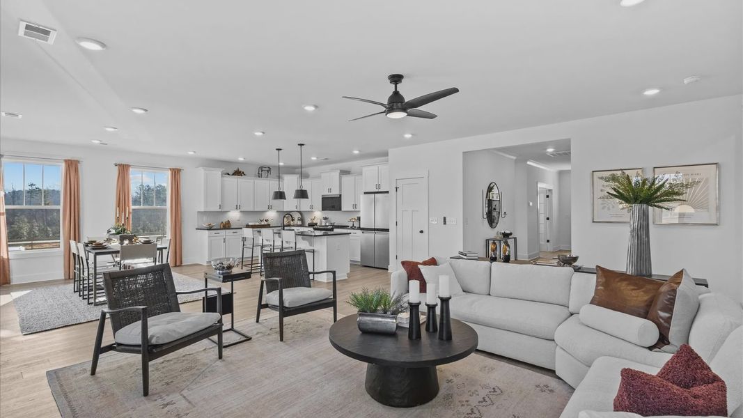 Spacious, modern family room with black accents and hardwood flooring at Wells Crossing by DRB Homes in Seneca, SC