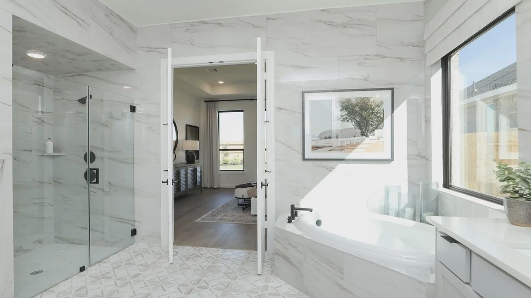 Brookewater's bathroom boasts elegant marble tiles, a luxurious soaking tub, and expansive glass shower. Brookewater's bathroom boasts elegant marble tiles, a luxurious soaking tub, and expansive glass shower.