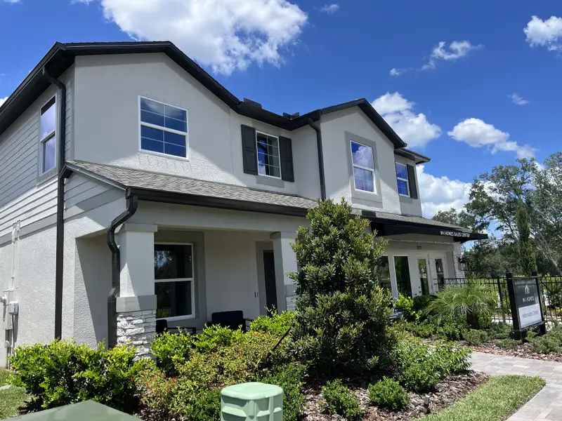 A beautiful two-story home with lush landscaping in Meadow Oaks by M/I Homes (Hudson, FL).