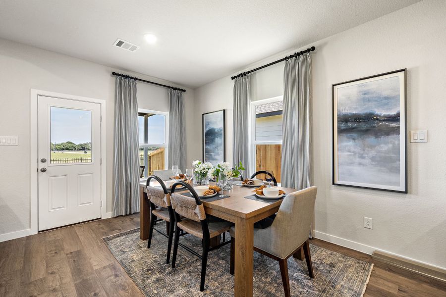 A dining room table with chairs.