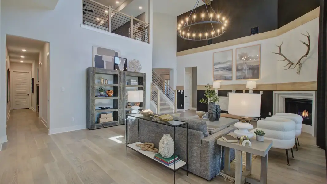 Exquisite high ceilings, polished wood floors, and grand chandelier exemplify luxury living at Verandas at the Rim.