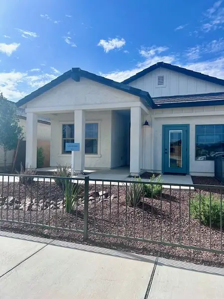 A charming modern home with a welcoming porch and desert landscaping in Monroe Ranch by K. Hovnanian® Homes (Buckeye, AZ).