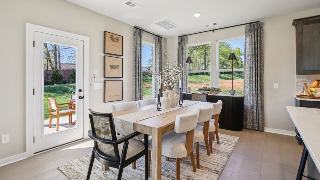 First floor dining area in-between kitchen and back door access to rear patio