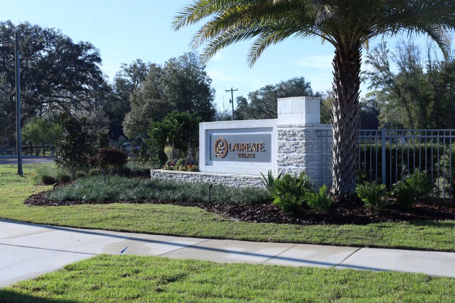 Entrance to the Laureate Village community in Newberry, FL, featuring signage and landscaping (Image 1). Entrance to the Laureate Village community in Newberry, FL, featuring signage and landscaping (Image 1).