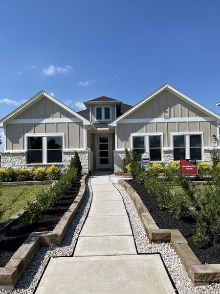 A charming modern home with a landscaped entry in Laurel Landing by Coventry Homes (Alvin, TX).