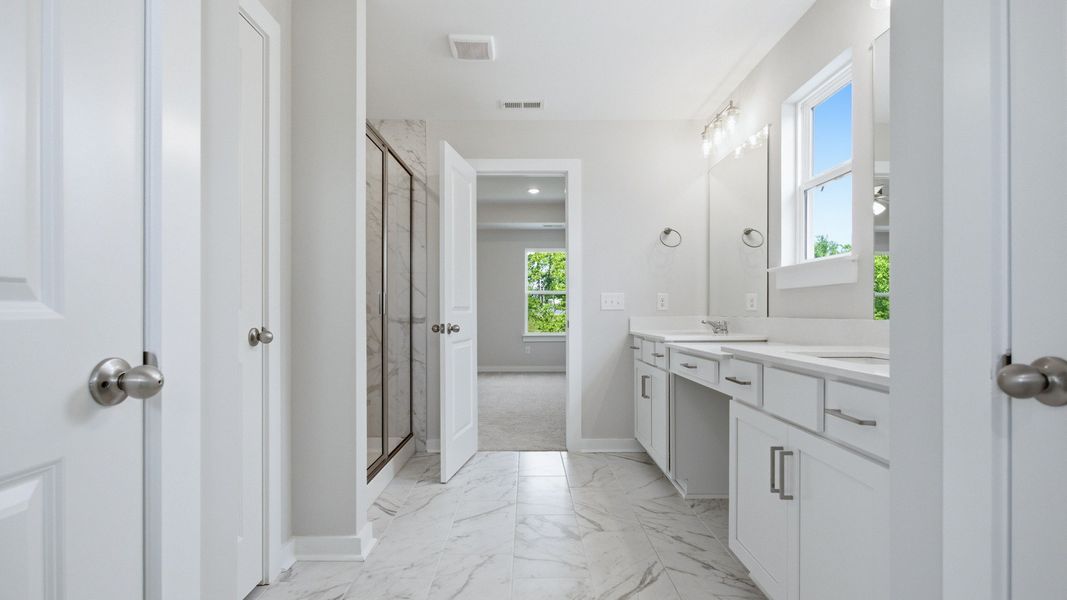 Primary bathroom with tile flooring and shower, and a dual sink vanity area for unwinding or preparing for your day. Primary bathroom with tile flooring and shower, and a dual sink vanity area for unwinding or preparing for your day.