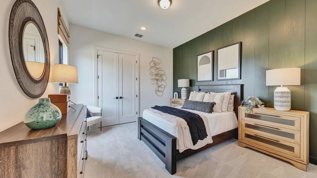 Discover refined elegance with dark wood elements and a striking green feature wall in Hawkes Landing.