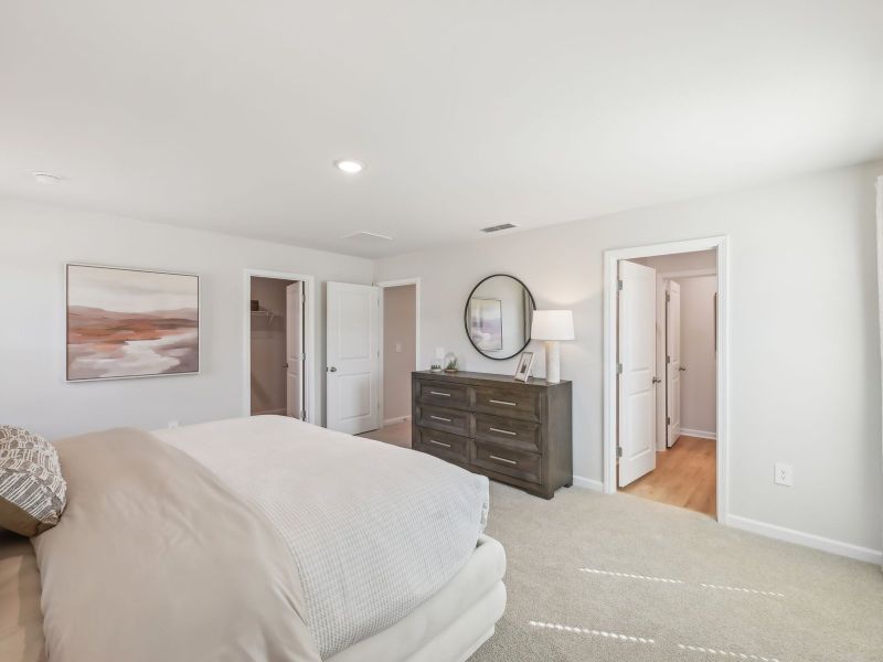 The spacious primary suite features a large walk-in closet and an ensuite bath. The spacious primary suite features a large walk-in closet and an ensuite bath.