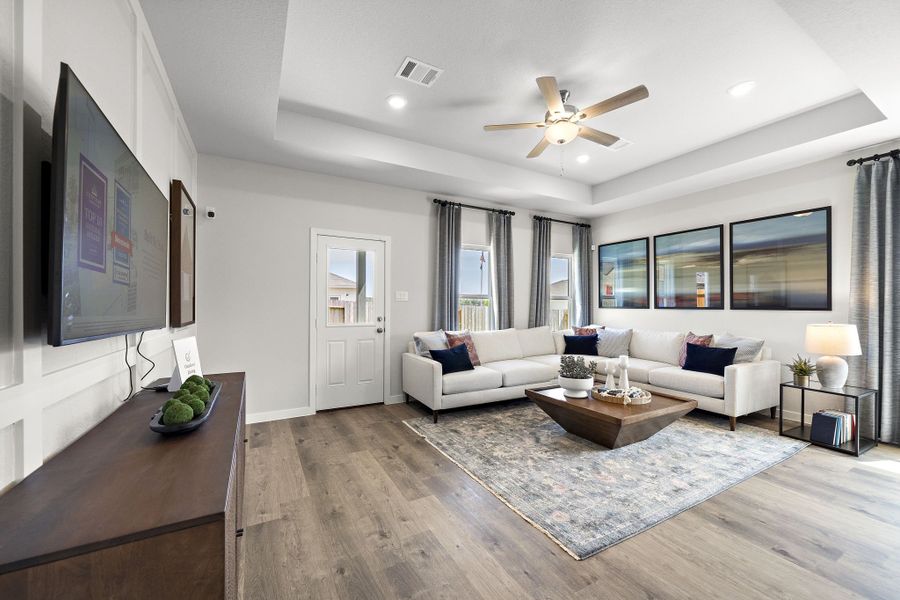 A living room with a large television and a couch.