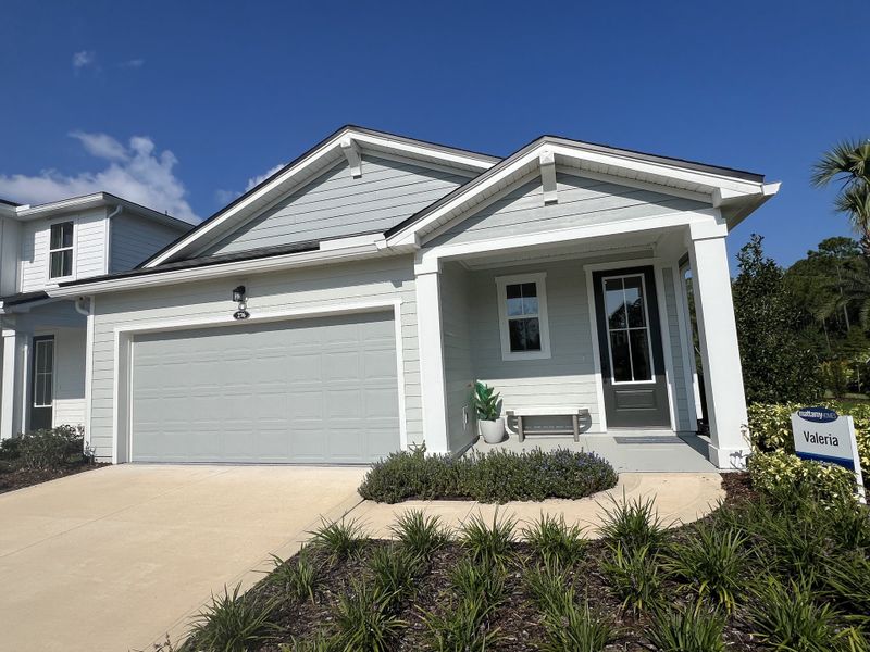 A charming gray home with a welcoming porch in RiverTown - Arbors West by Mattamy Homes (St. Johns, FL).