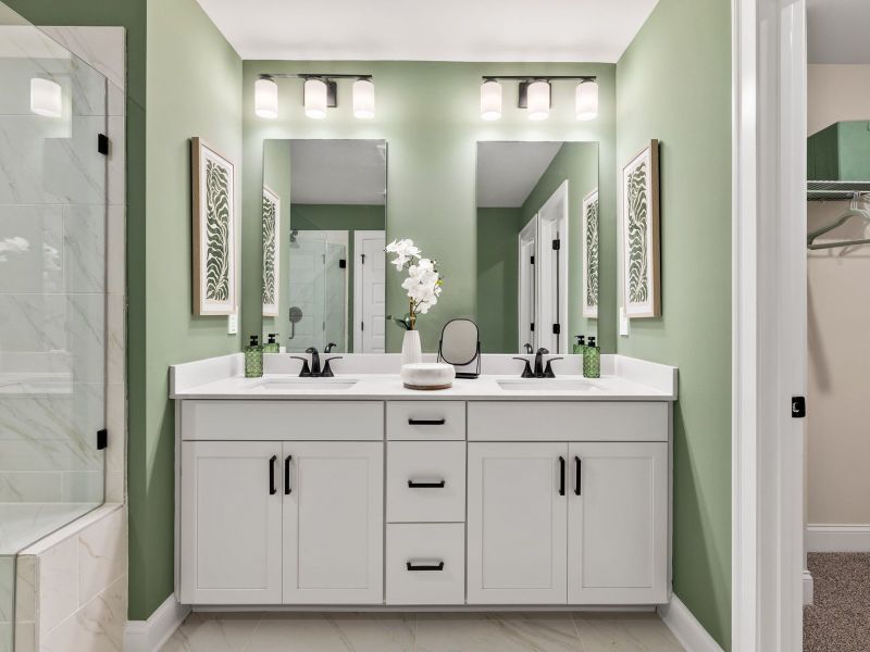 The primary bathroom boasts a dual-sink vanity with storage for your self-care essentials.