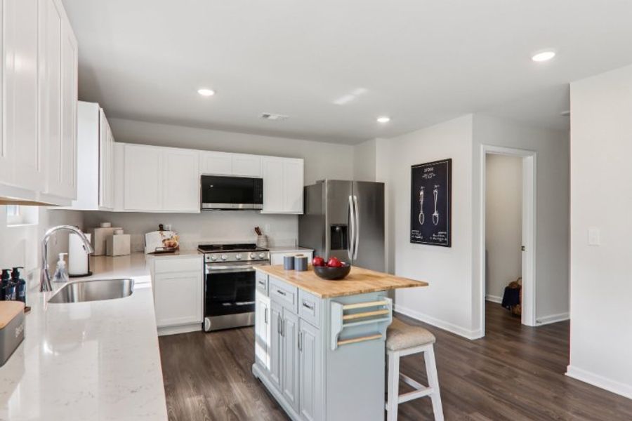 A kitchen with white cabinets.