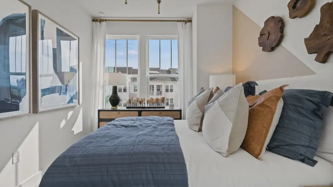 The second bedroom at Parkview at Hamlin by DRB Homes features a large window that fills the room with natural light