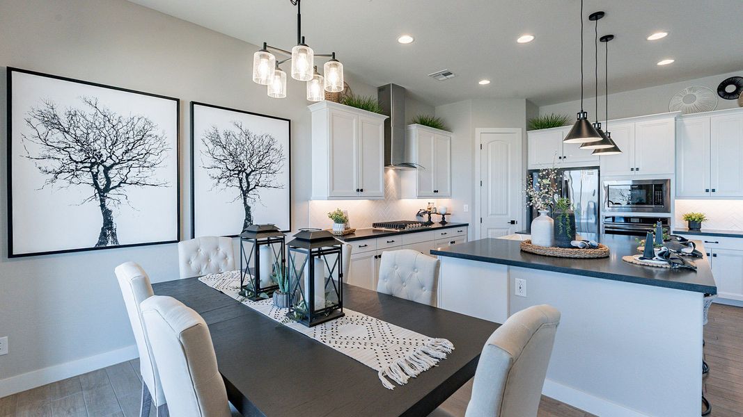 Elegant black countertops and sleek pendant lights enhance this Arroyo Seco Hacienda kitchen. Elegant black countertops and sleek pendant lights enhance this Arroyo Seco Hacienda kitchen.