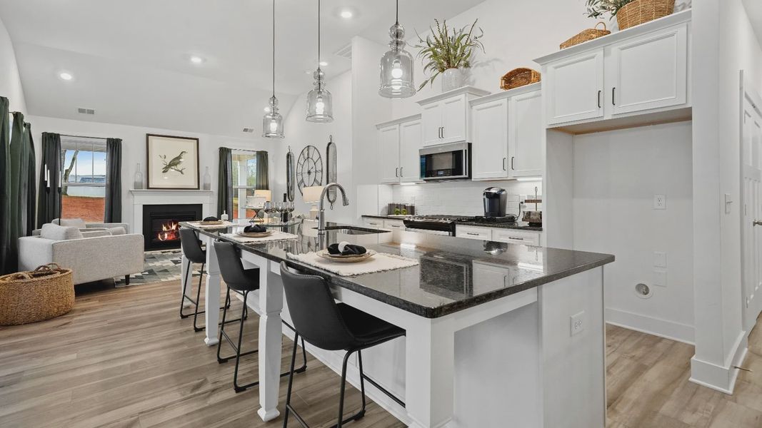Large kitchen with white cabinetry, black granite countertops & modern appliances at Pinebrook by DRB Homes in Woodruff, SC Large kitchen with white cabinetry, black granite countertops & modern appliances at Pinebrook by DRB Homes in Woodruff, SC
